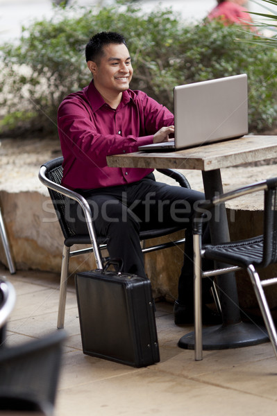 Hispanic Businessman - Telecommuting from Internet Cafe Stock photo © dgilder