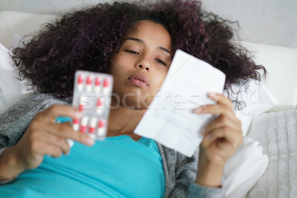Latino teen Bett home Aufnahme Pille Stock foto © diego_cervo