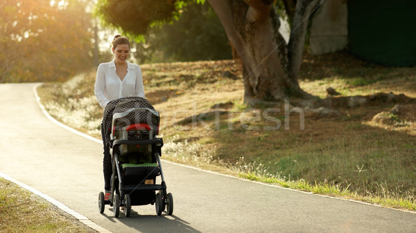 Woman Mother Mom With Toddler in Pushchair Walking In Park Stock photo © diego_cervo
