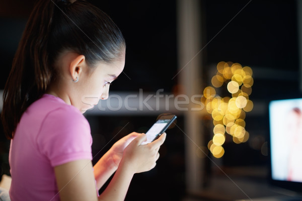 Unattended Daughter Writes On Social Network With Phone Stock photo © diego_cervo