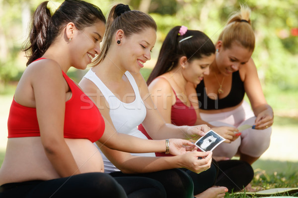 Pregnant Women Sharing Ecography Images In Prenatal Class Stock photo © diego_cervo