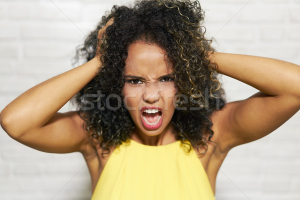 Facial Expressions Of Young Black Woman On Brick Wall Stock photo © diego_cervo