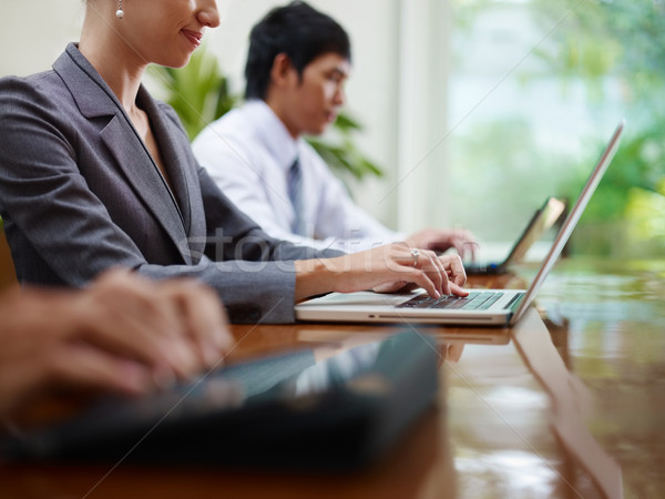 Stock photo: business man and women typing on pc during meeting 