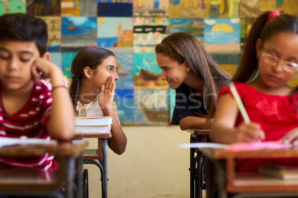 Stock photo: Girls Cheating During Admission Test In Class At School