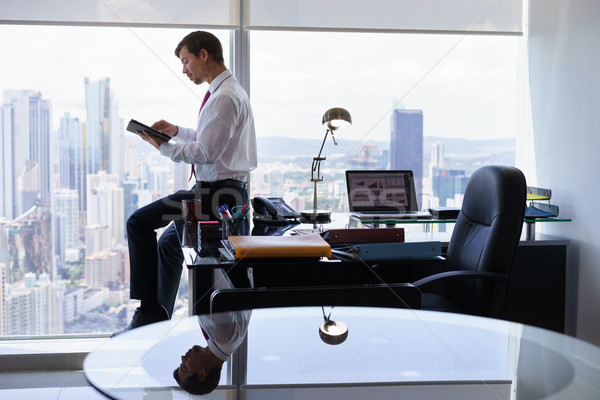 Business Person Reads News On Tablet PC In The Morning Stock photo © diego_cervo