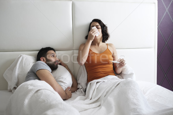 Young Woman Sneezing For Cold In Bed With Man Stock photo © diego_cervo