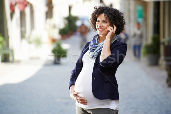 happy pregnant woman talking on the phone Stock photo © diego_cervo