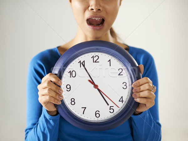 asian girl holding big blue clock with stress Stock photo © diego_cervo
