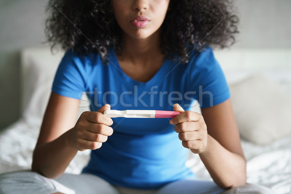 Triste jeune femme test de grossesse maison désappointé hispanique [[stock_photo]] © diego_cervo
