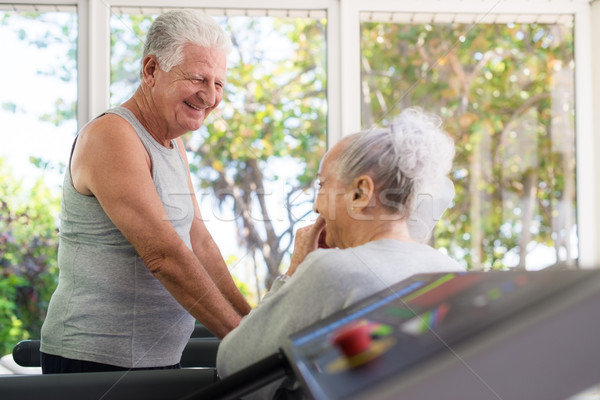 Active senior friends talking and working out in fitness club Stock photo © diego_cervo