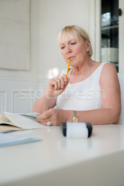 Mature woman checking bills and doing budget at home Stock photo © diego_cervo