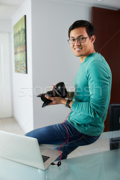 Asian Man Connect DSLR To PC Download Pictures On Laptop Stock photo © diego_cervo
