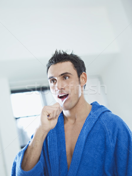Férfiszépség kaukázusi felnőtt férfi fürdőköpeny fogmosás Stock fotó © diego_cervo