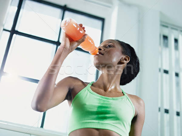 african woman in gym drinking energy drink Stock photo © diego_cervo