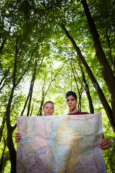 Stock photo: young couple looking at map during trek 