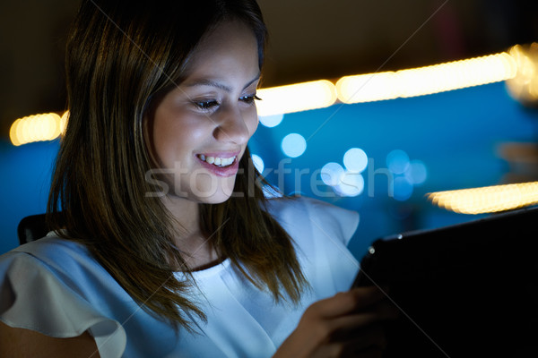 Stock photo: Young Student Using Tablet PC Indoor At Night