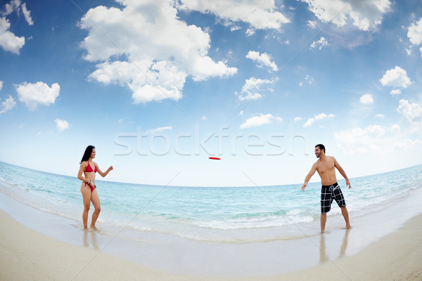 young happy man and woman playing with frisbee Stock photo © diego_cervo