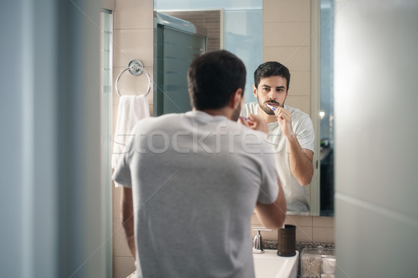 Stock photo: Hispanic Man Brushing Teeth In Bathroom At Morning