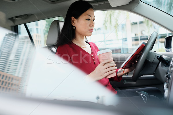 Busy Chinese Business Woman Working In Car With Tablet Stock photo © diego_cervo