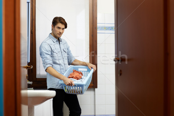 man doing chores with washing machine Stock photo © diego_cervo