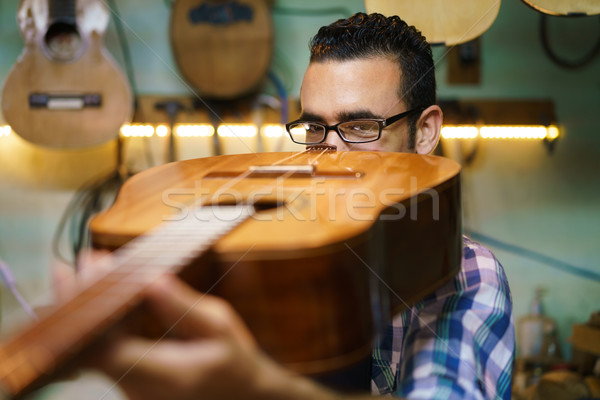 Lute Maker Checking Bridge And Arm Of Classic Guitar Stock photo © diego_cervo