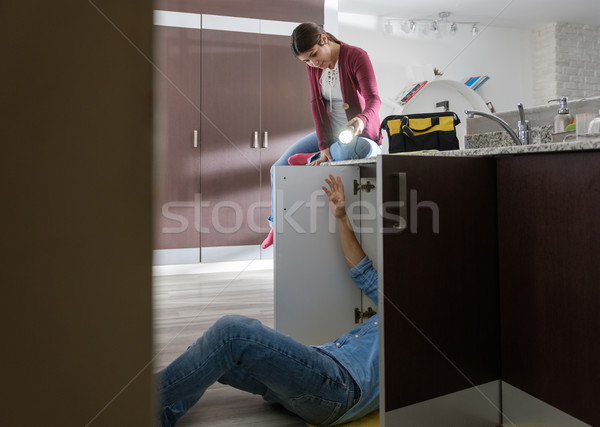 Handyman Husband and Wife Repairing Kitchen Sink Stock photo © diego_cervo