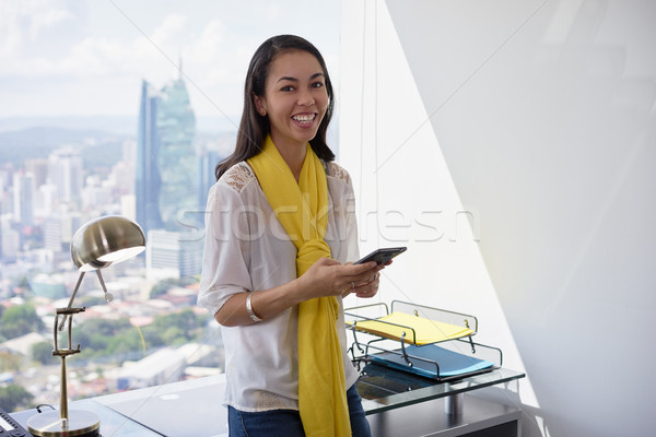 Young Latina Business Woman With Phone In Office 2 Stock photo © diego_cervo