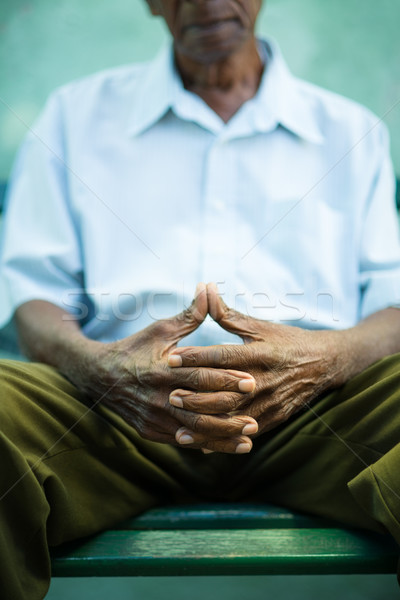 pensive old man sitting on bench in park Stock photo © diego_cervo