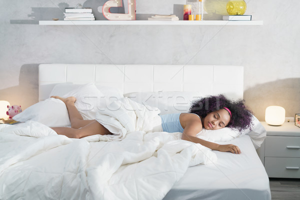 Afroamerikai nő alszik egyedül nagy ágy fiatal Stock fotó © diego_cervo