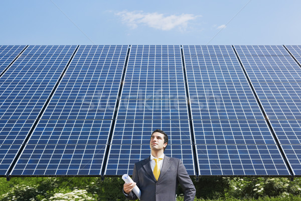 businessman standing near solar panels Stock photo © diego_cervo