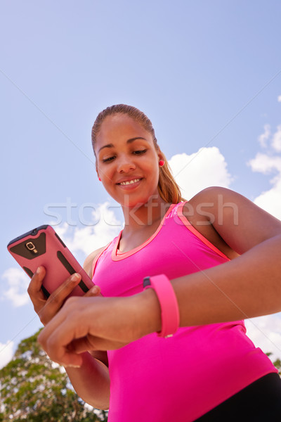Young Woman Connecting Fitness Watch Fitwatch With Phone Stock photo © diego_cervo