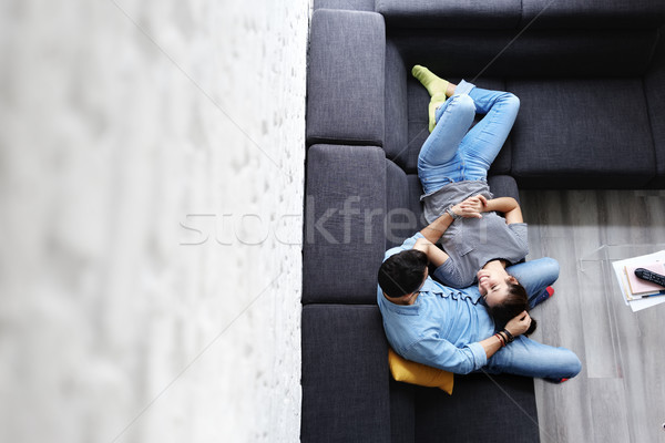 Young Couple Hugging and Laughing on Sofa Stock photo © diego_cervo