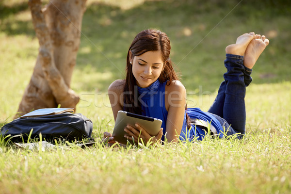 Stock photo: Woman with books and ipad studying for college test