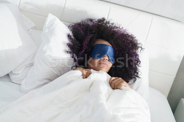 Tired Black Girl Waking Up In Bed With Sleep Mask Stock photo © diego_cervo