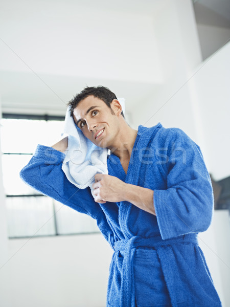 Jovem caucasiano homem azul roupão de banho Foto stock © diego_cervo