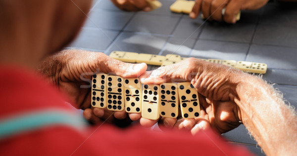 Fekete nyugdíjas idős férfi játszik dominó Stock fotó © diego_cervo