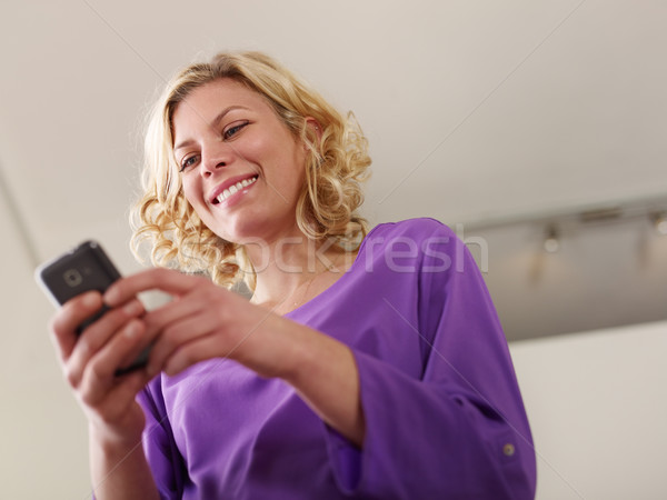 Boldog fiatal nő gépel szöveges üzenet mobiltelefon fiatal Stock fotó © diego_cervo
