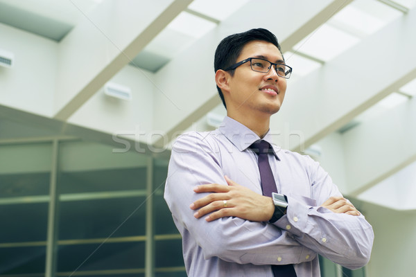 Portrait Chinese Businessman Contemplating Office Skyscraper Stock photo © diego_cervo