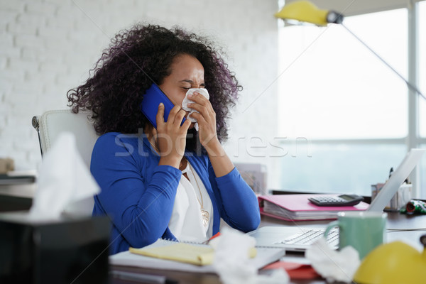 Sick Black Woman Working from Home Sneezing For Cold Stock photo © diego_cervo