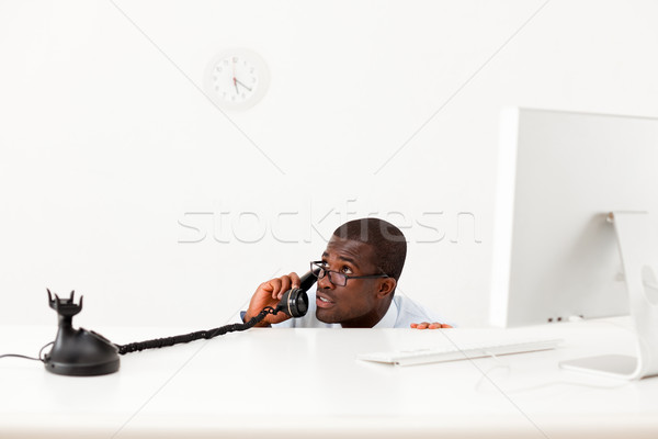 businessman hiding behind desk Stock photo © diego_cervo