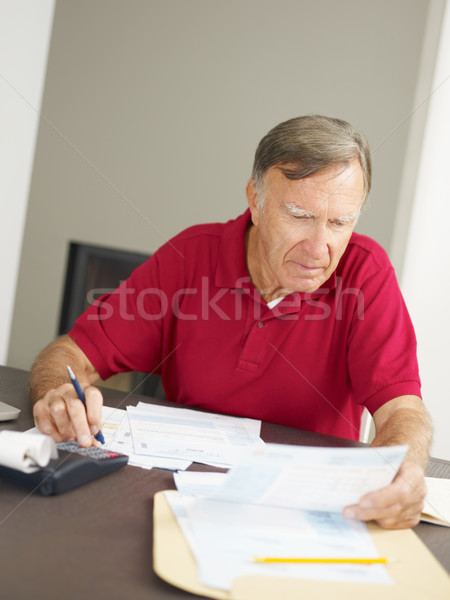 Senior man checking home finances Stock photo © diego_cervo