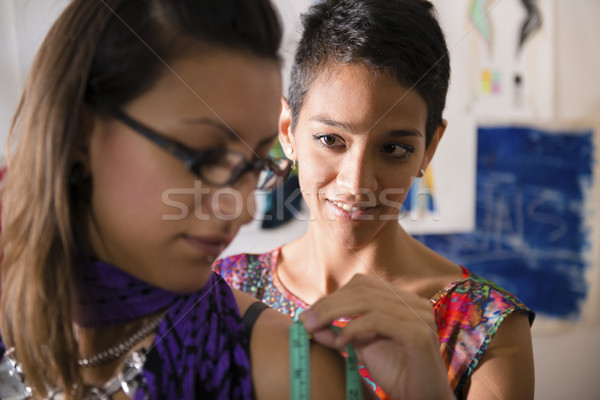 Fashion designer using measuring tape with client Stock photo © diego_cervo