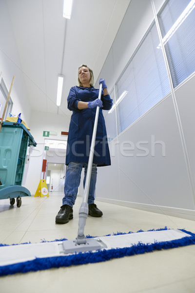 Women at workplace, professional female cleaner sweeping floor i Stock photo © diego_cervo