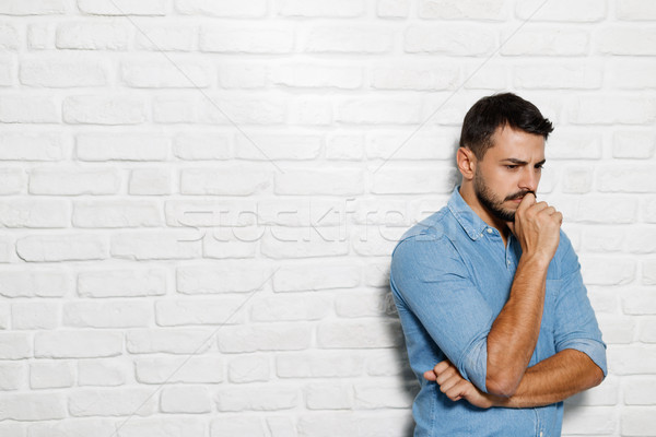 Facial Expressions Of Young Beard Man On Brick Wall Stock photo © diego_cervo