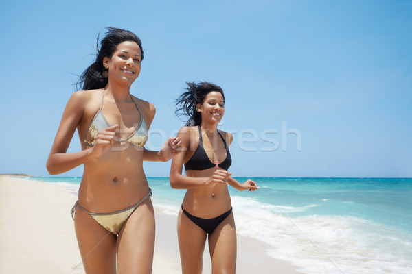 latina sisters in bikini on beach near caribbean sea Stock photo © diego_cervo
