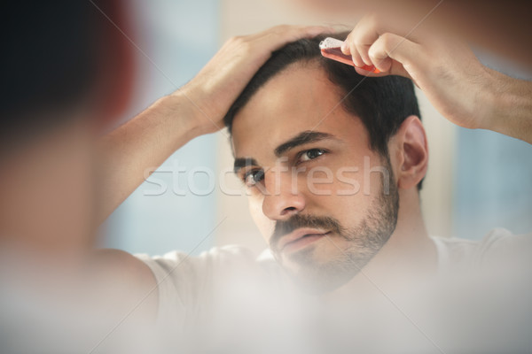Young Man Applying Lotion For Alopecia And Hair Loss Treatment Stock photo © diego_cervo