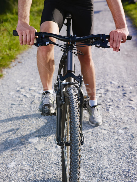 Stock photo: young man training on mountain bike 