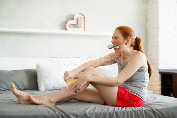Redhead Woman Feeling Pain Waxing Her Legs Stock photo © diego_cervo