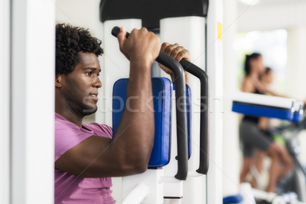 Young african american man training in fitness gym Stock photo © diego_cervo