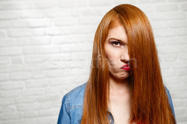 Facial Expressions Of Young Redhead Woman On Brick Wall Stock photo © diego_cervo